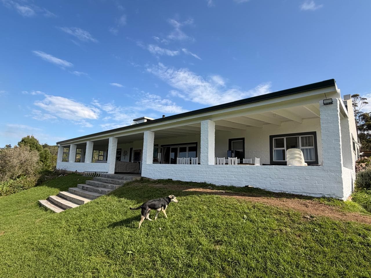 The finished house from the lawn, roof and veranda fully restored