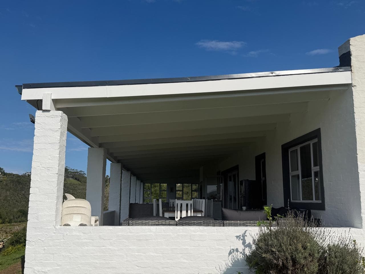 The restored roof edge and veranda corner overlooking the valley